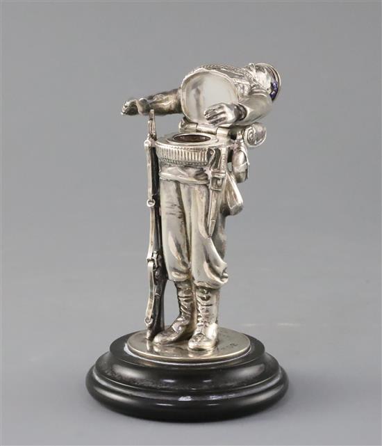 A late Victorian novelty silver and enamel inkwell, modelled as a sailor from HMS Duke of Wellington, overall 17cm.